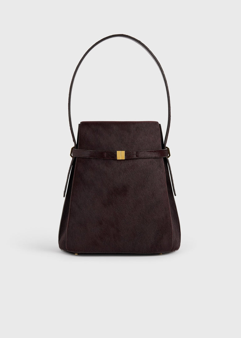 Belted pony hair bucket bag wine